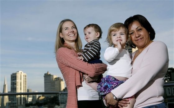 Roxanne Stachon, left, holds her 10-month-old son Scott McKinnon as her daughter Julia McKinnon, 2, is held by nanny Patty Granados in San Francisco. A group of parents is pushing for car-owning nannies to be included in San Francisco's residential parking permit program, which covers about 25 percent of its streets.